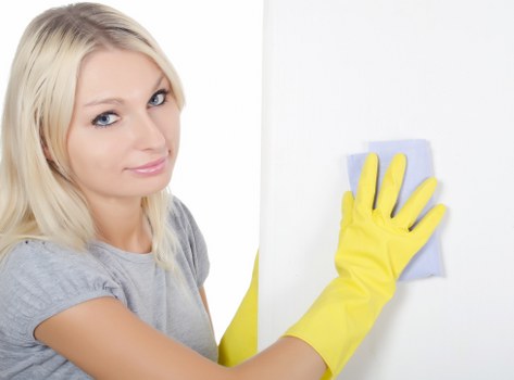 Homeowner vacuuming a fabric couch
